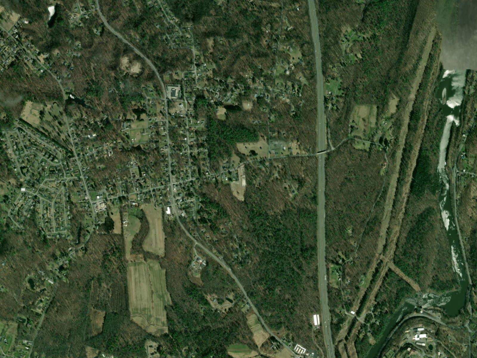 Wide aerial view of the Tillson hamlet and surrounding Hudson Valley landscape.